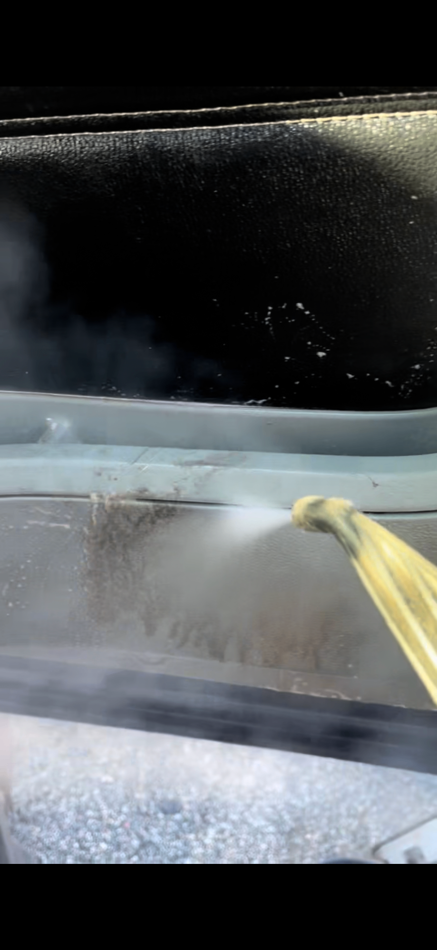 Interior steam cleaning a car dashboard