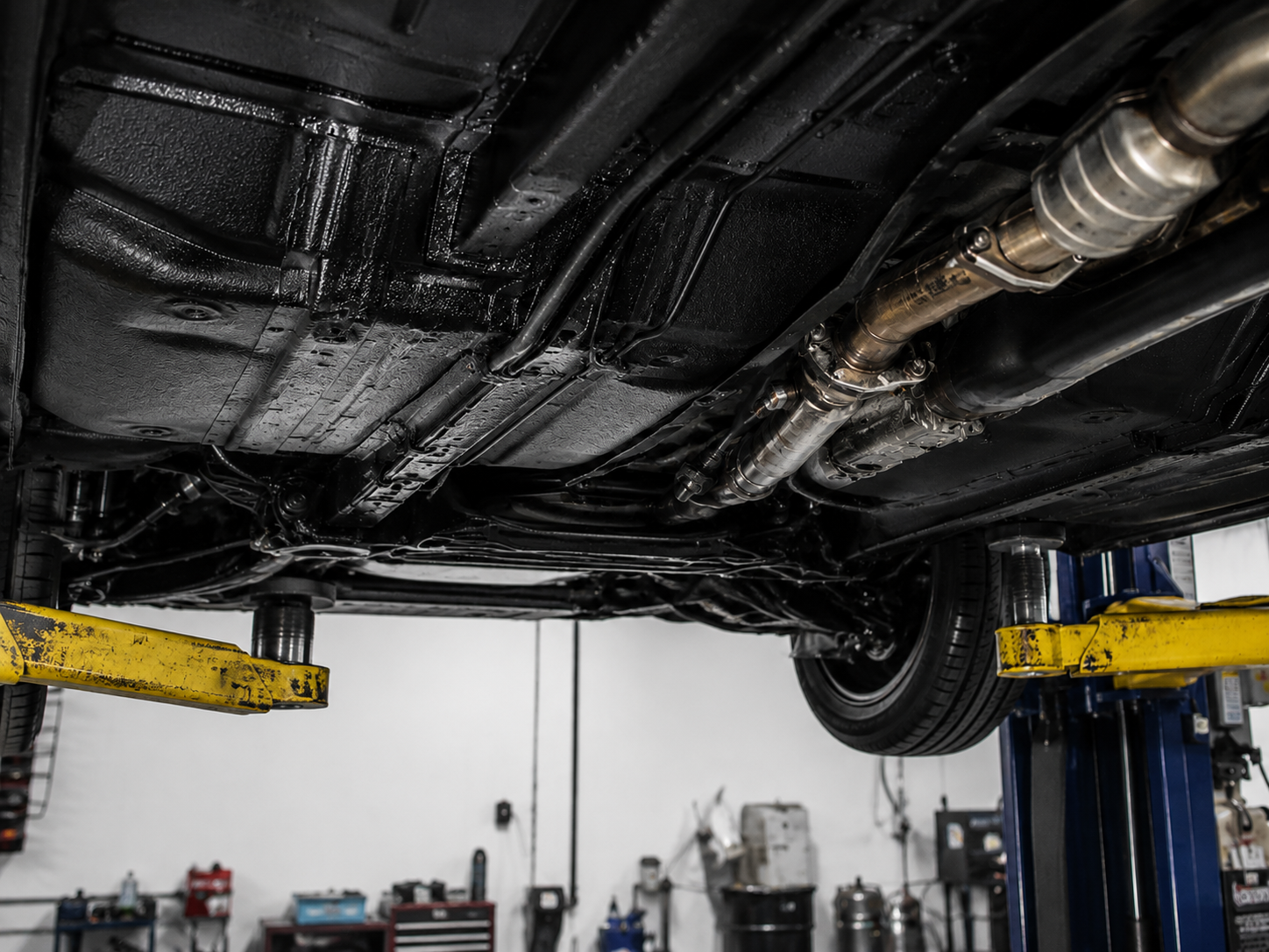 Freshly coated vehicle undercarriage on the lift