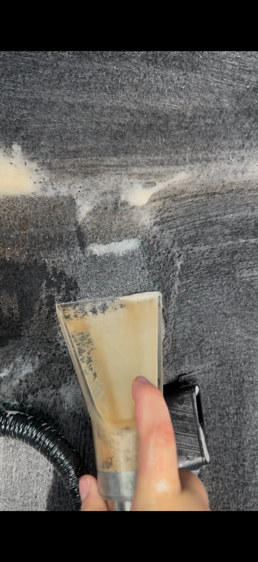 Extracting suds from a carpet during interior shampoo